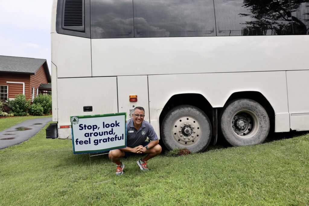 Camp staff in front of camp bus