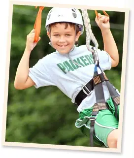 Boy camper riding zipline at Chestnut Lake Camp adventure park
